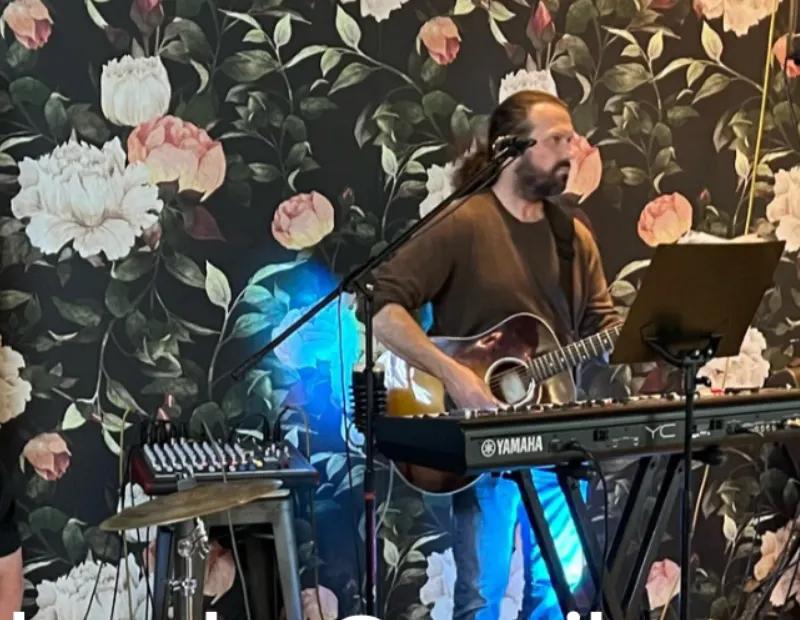 James Richard performing live with vocals, guitar, and keys